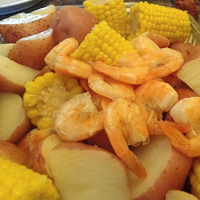 Don't be intimidated by a shrimp boil! This Super Easy Shrimp Boil recipe uses frozen corn and fully cooked shrimp and sausage - definitely an easy dinner!