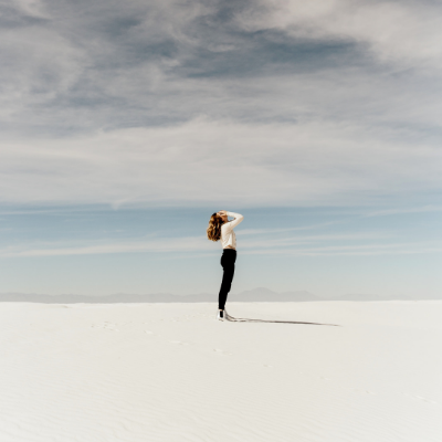 woman standing under a storm cloud