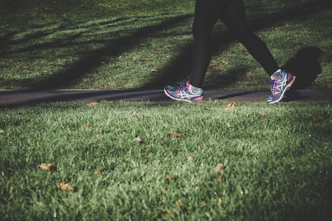 woman running through park