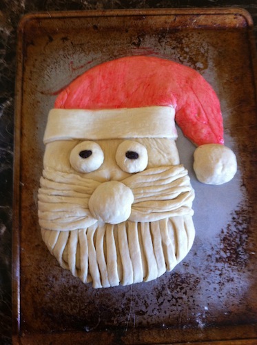 dough shaped as santa face with red hat