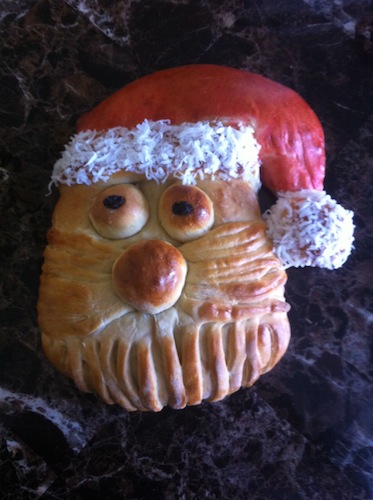 bread shaped as Santa face with coconut as white for hat band