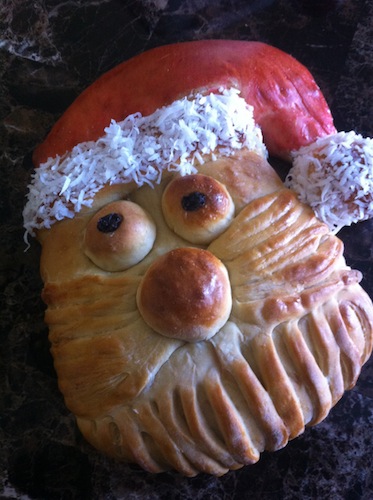 bread shaped as santa with red santa had