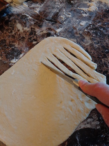 dough being cut into slices for beard