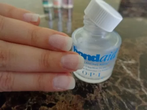 buffed finger nails in front of opi bondaid