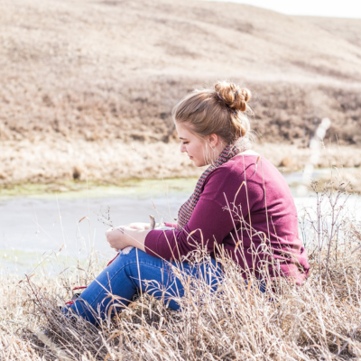woman sitting in a field