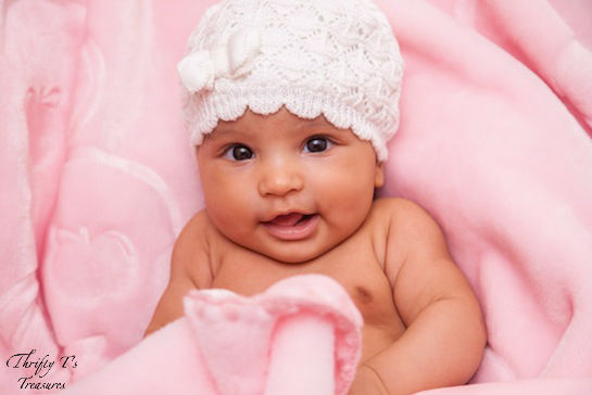 newborn baby girl with crocheted bonnet