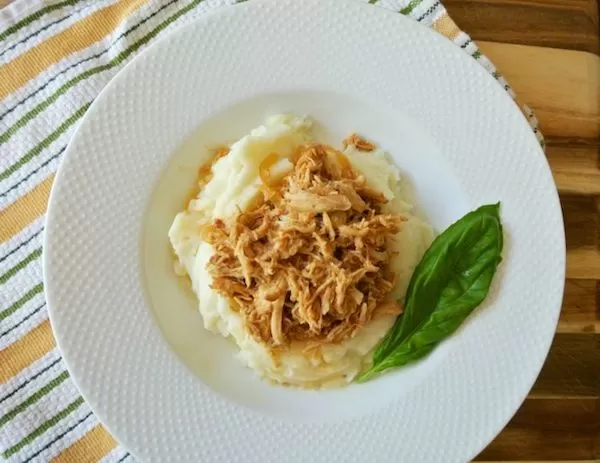 plate of shredded chicken over mashed potatoes