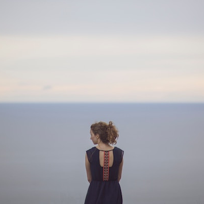 woman facing ocean