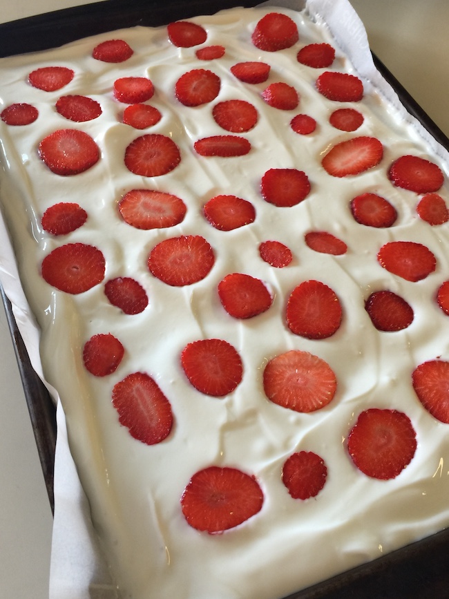 yogurt in a pan topped with sliced strawberries