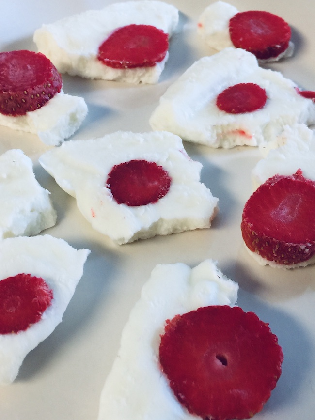 frozen yogurt pieces topped with sliced strawberries