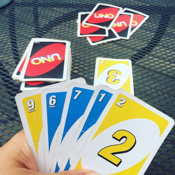 Playing American Card Game Uno, Holding Game Cards in Female Hand