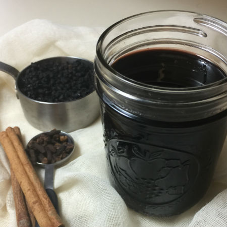 elderberry syrup, elderberries, cinnamon sticks and clove