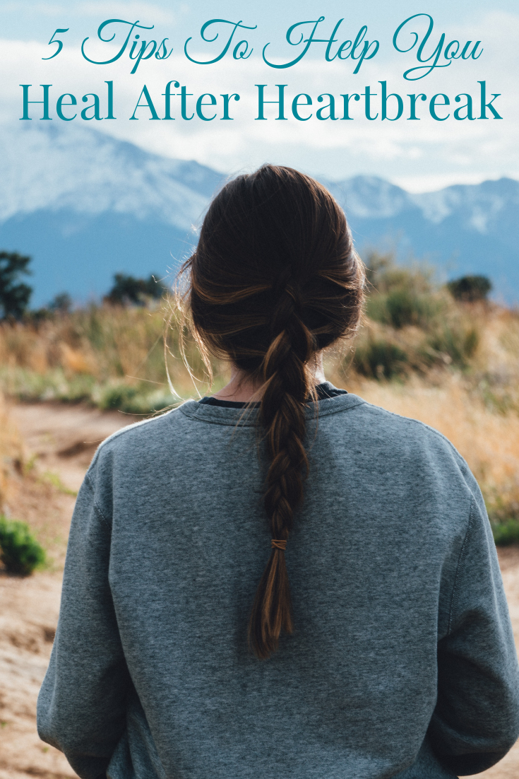 woman looking at the snow peaked mountaintops