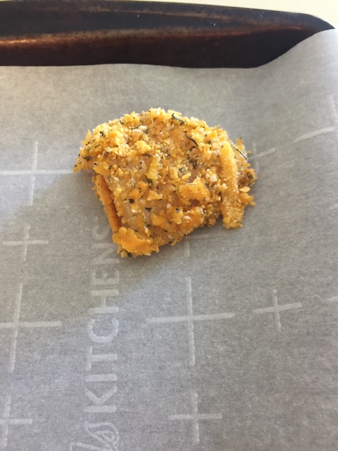 breaded chicken nugget on top of parchment paper