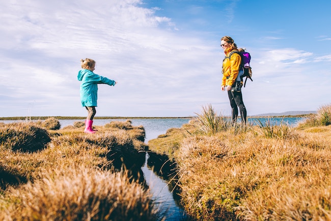 mom and daughter crossing lake