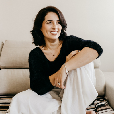 smiling woman sitting on couch