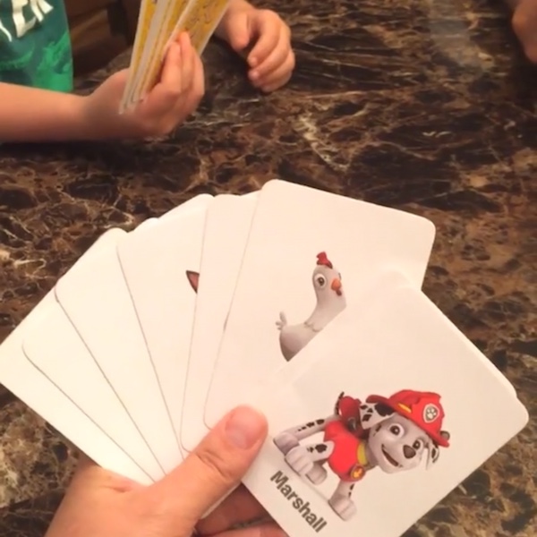 hand holding paw patrol playing cards