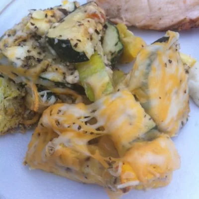 zucchini and squash topped with cheese and spices