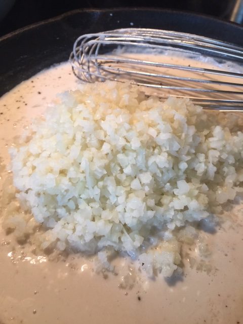 riced cauliflower on top of cream cheese and almond milk