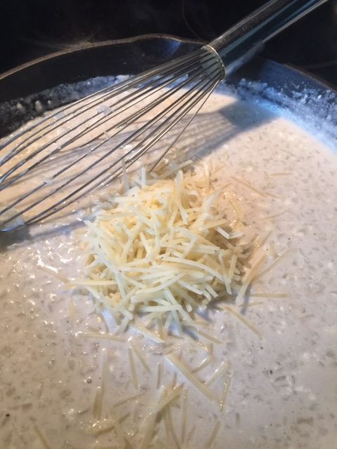 parmesan cheese on top of riced cauliflower risotto