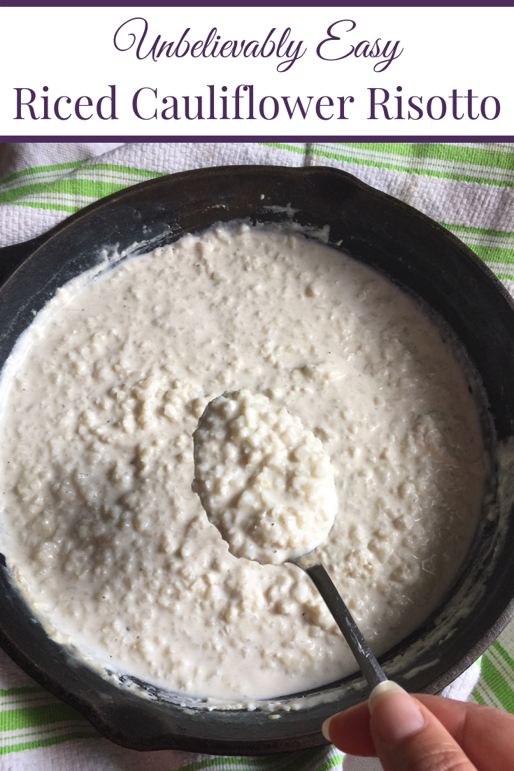 spoon full of riced cauliflower risotto over top of cast iron skillet