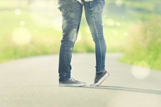 couple facing each other with girl standing on tip toes