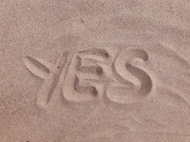 yes text on brown sand