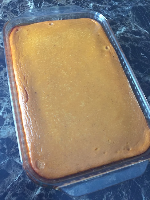 pumpkin cheesecake bar on plate beside pan