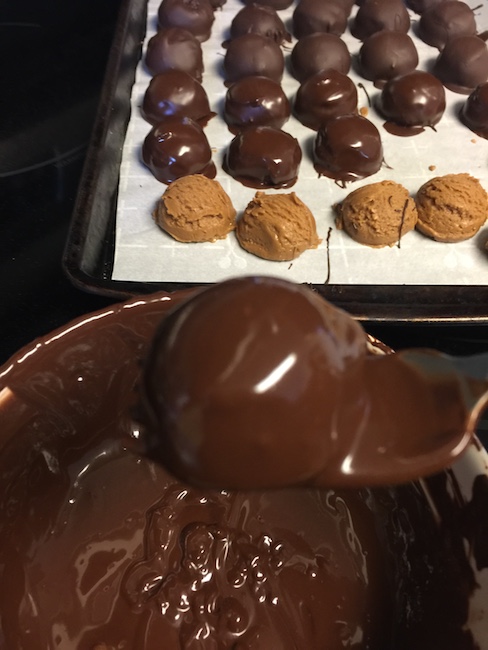 peanut butter ball dipped in melted chocolate