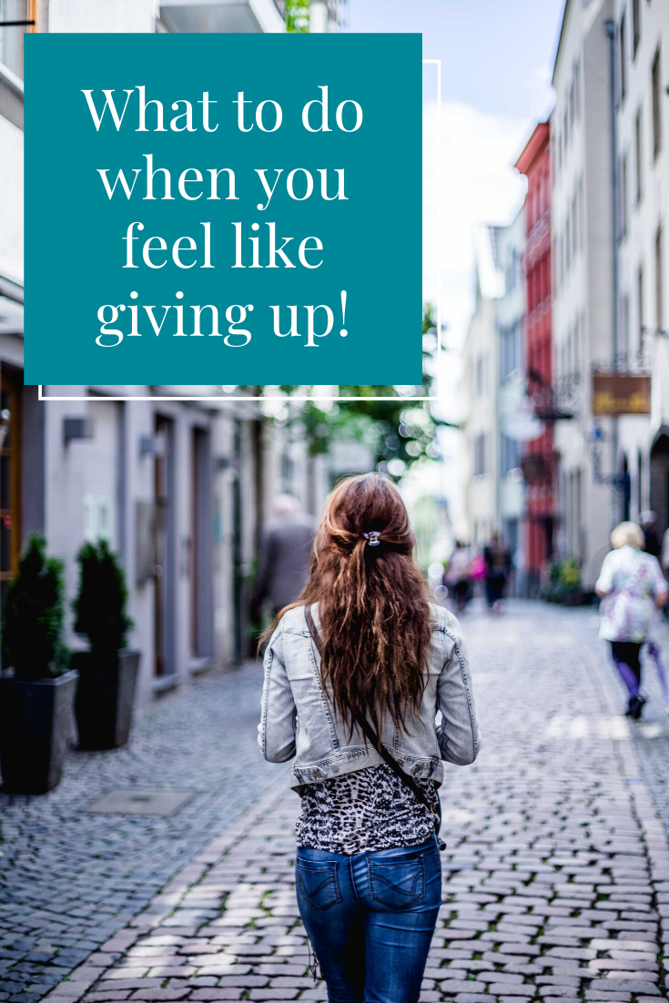 girl walking down cobblestone street - what to do when you feel like giving up