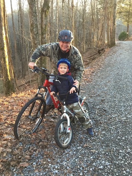 father and son riding bikes