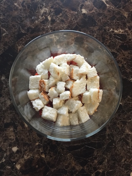 cubed angel food cake in trifle bowl