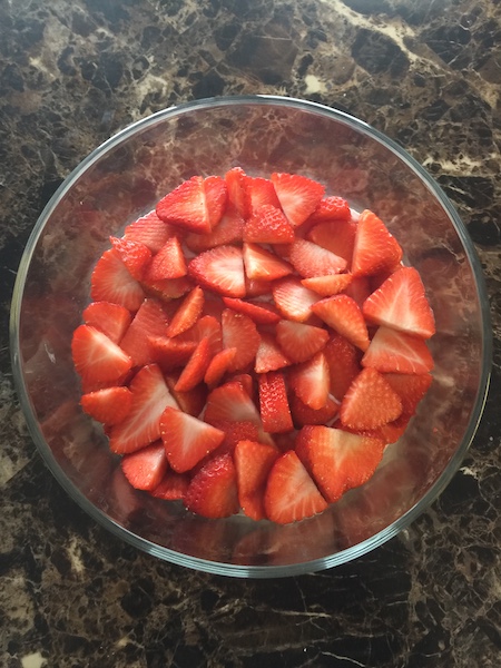 sliced strawberries in trifle bowl