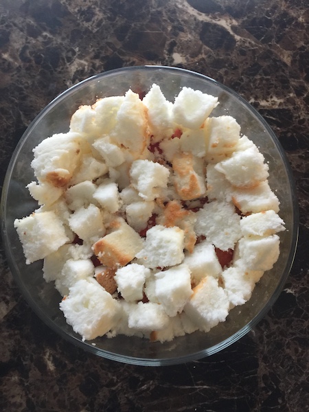 cubed angel food cake in trifle bowl