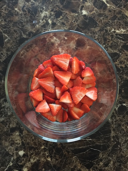 sliced strawberries in trifle bowl