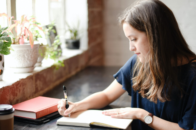 woman writing in a journal