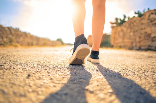 feet walking on a gravel path