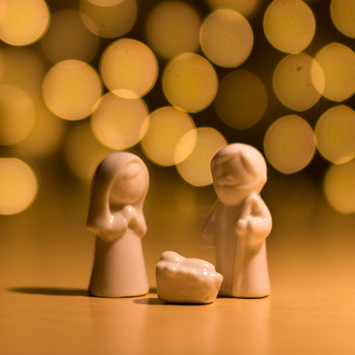 simple, porcelain nativity scene with Mary, Joseph and baby Jesus in the manger