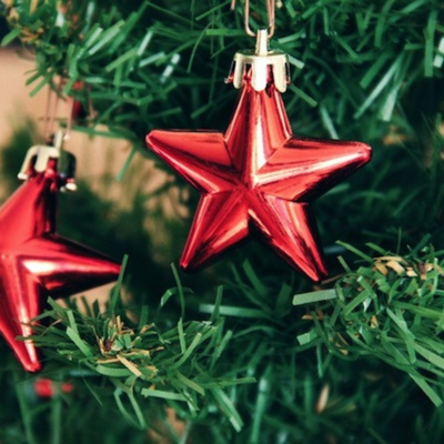 red star ornamets hanging on a christmas tree