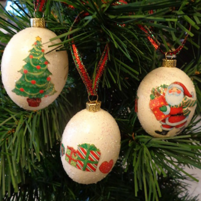 eggs ornaments with christmas trees, Santa and gifts hanging on a tree