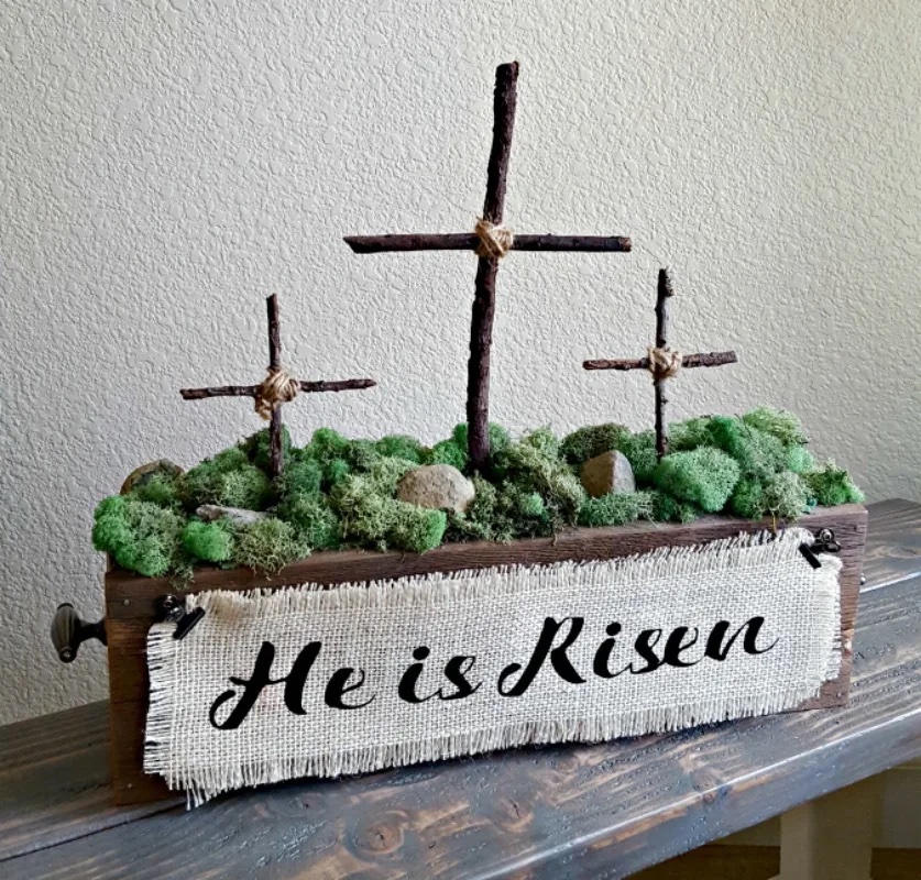 centerpiece with twig crosses, moss and and He is Risen banner 