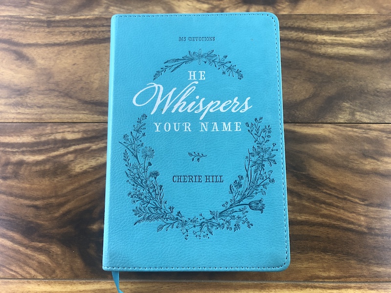 he whispers your name devotional on top of wooden floor