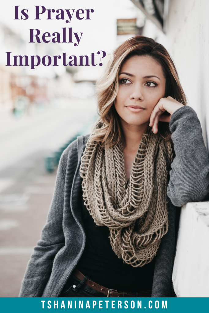 woman leaning against a wall thinking