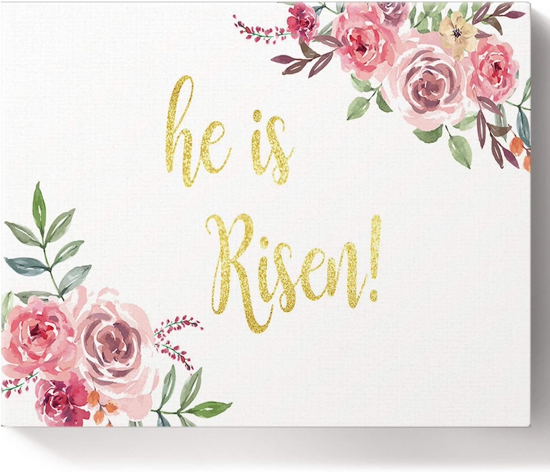 pink watercolor painting with he is risen written in gold