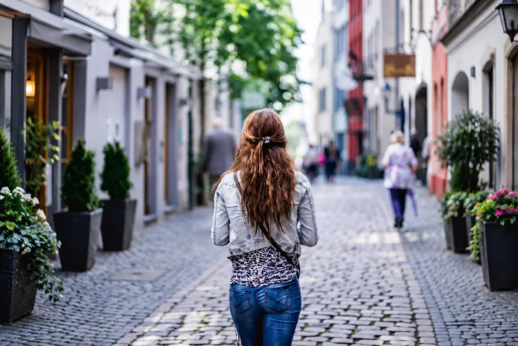 Woman walking down a quiet street when she feels like giving up