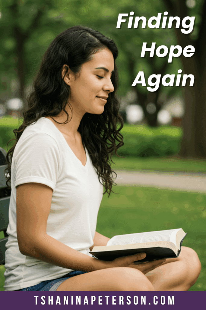 Christian woman sitting under a tree reading her Bible and finding hope after heartache