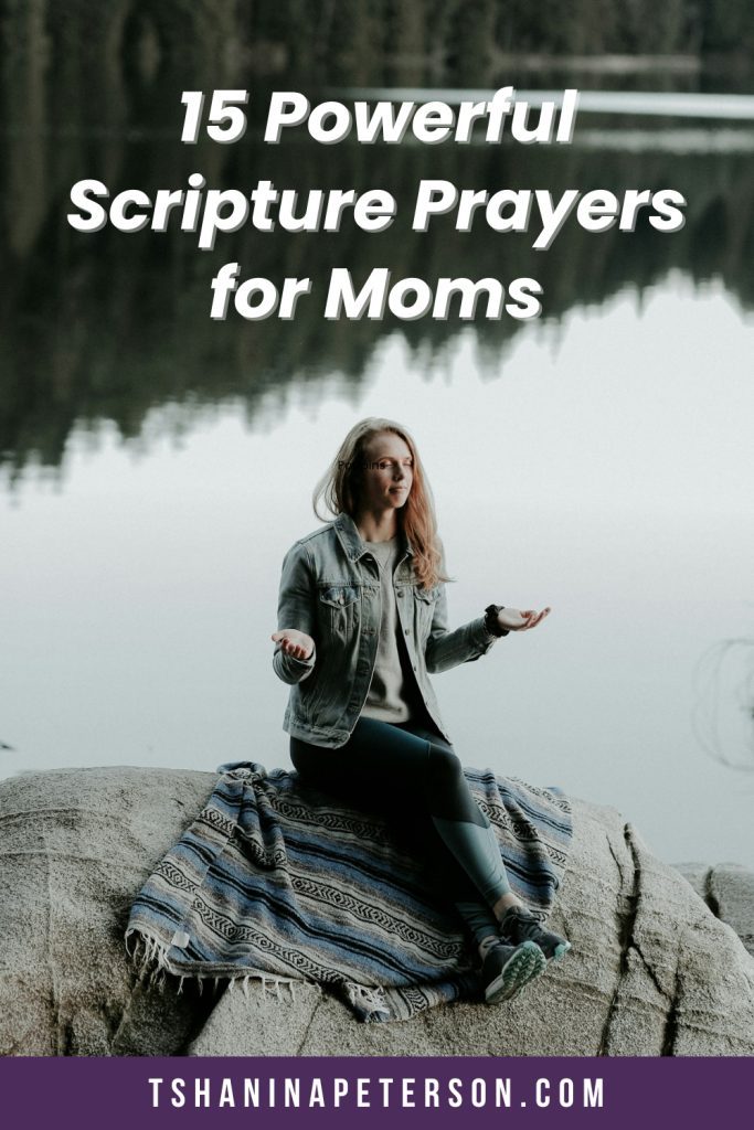 woman with opened hands praying on rock at the lake