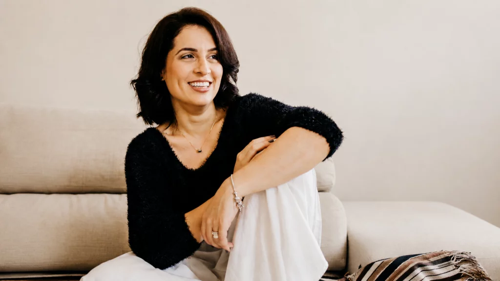 Woman relaxing on couch representing stress relief and emotional rest
