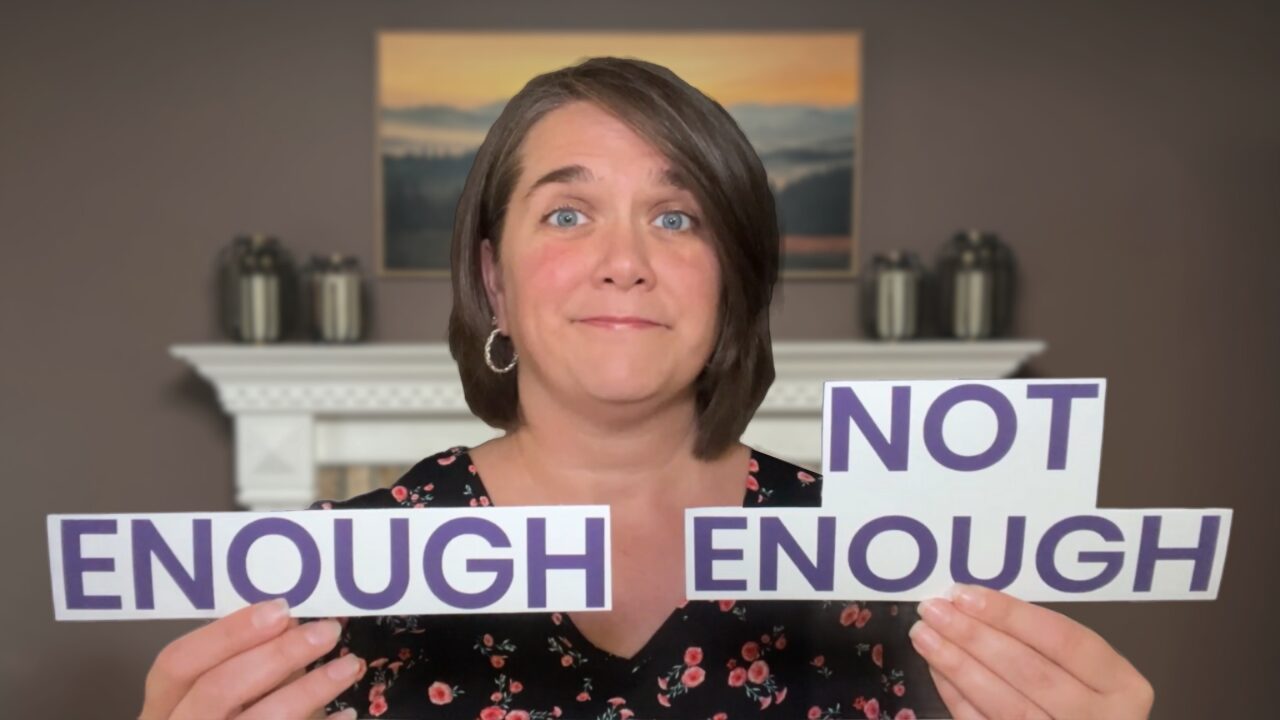 woman holding enough and not enough signs